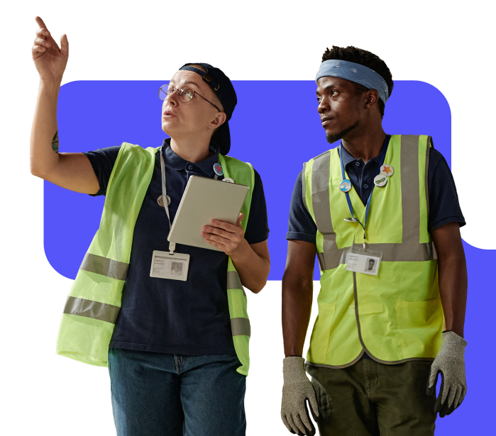 Two factory workers checking equipment.