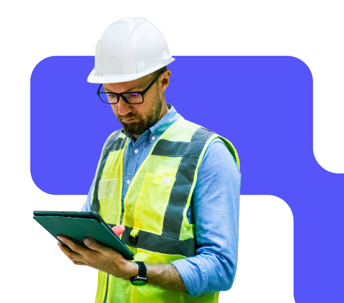 Worker in hardhat checking his ipad.
