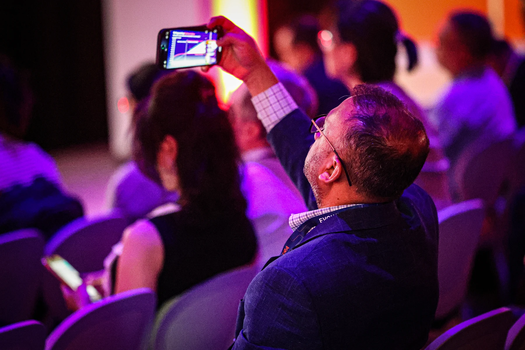 Attendees taking videos of the session events